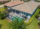 Aerial view of screened pool with patio, landscaping, and a glimpse of the home's exterior at 5632 Long Shore Loop, Sarasota, FL 34238
