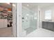 Modern bathroom featuring a walk-in shower with dual shower heads, and marble floors at 5632 Long Shore Loop, Sarasota, FL 34238