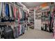 Spacious walk-in closet with custom shelving, drawers, and ample storage for clothes and accessories at 5632 Long Shore Loop, Sarasota, FL 34238
