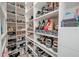 Organized walk-in closet featuring built-in shoe racks and shelves for easy access to footwear at 5632 Long Shore Loop, Sarasota, FL 34238