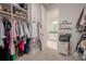 Walk-in closet with custom shelving and closet rods connected to the bathroom at 5632 Long Shore Loop, Sarasota, FL 34238