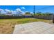Large, fenced backyard with a grassy area and a concrete patio at 5755 Oxalis Rd, Venice, FL 34293