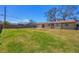 Expansive backyard featuring lush green grass and a wooden fence, perfect for outdoor activities and entertaining at 5755 Oxalis Rd, Venice, FL 34293