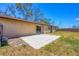 The backyard features a concrete patio with a sliding glass door to the home at 5755 Oxalis Rd, Venice, FL 34293