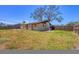 This yard is spacious with a partial privacy fence and a home with tan siding at 5755 Oxalis Rd, Venice, FL 34293