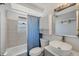 Updated bathroom features a tub/shower, sleek vanity, modern sink, and storage at 5755 Oxalis Rd, Venice, FL 34293