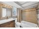 Bathroom featuring updated vanity, modern fixtures, tile surround and shower/tub at 5755 Oxalis Rd, Venice, FL 34293