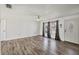 Bright living room with new hardwood flooring, ceiling fan, white walls, and abundant natural light at 5755 Oxalis Rd, Venice, FL 34293