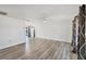 Spacious living room with hardwood flooring, white walls, ceiling fan and views of the backyard and pool at 5755 Oxalis Rd, Venice, FL 34293