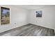 Bright living room offers wood-look flooring and an abundance of natural light at 5755 Oxalis Rd, Venice, FL 34293