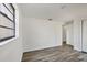Bright room offers neutral walls, wood-look flooring, a window, and ample space at 5755 Oxalis Rd, Venice, FL 34293