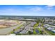Stunning aerial view of a residential community with picturesque landscaping, and adjacent bodies of water at 5800 Sabal Trace Dr # 101, North Port, FL 34287