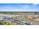 Beautiful aerial view overlooking properties near a tranquil pond and ongoing construction site at 5800 Sabal Trace Dr # 101, North Port, FL 34287