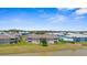 Rear view showcasing spacious green lawns extending to a serene pond from condo balconies at 5800 Sabal Trace Dr # 101, North Port, FL 34287