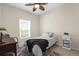 Cozy bedroom with a white comforter, a patterned rug, a side table with storage, and a bright window at 5800 Sabal Trace Dr # 101, North Port, FL 34287