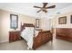 A calming bedroom featuring neutral tones, a wooden bed, framed pictures, and bright, natural light at 5800 Sabal Trace Dr # 101, North Port, FL 34287