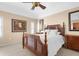 A serene bedroom with a wooden bed frame, neutral walls, and ample natural light from the large windows at 5800 Sabal Trace Dr # 101, North Port, FL 34287