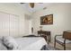 Bright bedroom featuring a white comforter, a patterned rug, a vintage desk, and a closet at 5800 Sabal Trace Dr # 101, North Port, FL 34287