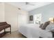 Charming bedroom featuring neutral tones, a white comforter, a wooden desk, and a bright window at 5800 Sabal Trace Dr # 101, North Port, FL 34287