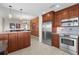 Gourmet kitchen featuring stainless steel appliances, granite countertops, and wooden cabinetry at 5800 Sabal Trace Dr # 101, North Port, FL 34287