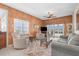 Comfortable living room featuring a cozy seating arrangement, textured walls, and sliding glass doors to the outside at 5800 Sabal Trace Dr # 101, North Port, FL 34287