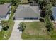 Aerial view of a single-story home with a well-manicured lawn and a long driveway at 5931 Plover Rd, Venice, FL 34293