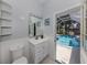 Well-lit bathroom featuring an exit to the pool, a vanity with a sink and a toilet at 5931 Plover Rd, Venice, FL 34293