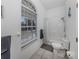 Bright bathroom with a large window, a shower and a tiled bath with integrated shower at 5931 Plover Rd, Venice, FL 34293