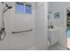 Bright bathroom featuring a tiled walk-in shower with grab bar, vanity, and window at 5931 Plover Rd, Venice, FL 34293