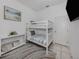 Cozy bedroom featuring a bunk bed with striped bedding and a decorative nautical theme at 5931 Plover Rd, Venice, FL 34293