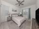 Bright primary bedroom featuring neutral tones, a ceiling fan and a view to the exterior at 5931 Plover Rd, Venice, FL 34293
