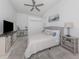 Well-lit primary bedroom, featuring neutral tones, a ceiling fan and a work desk at 5931 Plover Rd, Venice, FL 34293