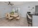 Bright dining area featuring tile floors, bar seating and sliding glass doors at 5931 Plover Rd, Venice, FL 34293