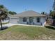 Lovely single-story home featuring a clean white exterior, attached garage, and a well-kept front yard at 5931 Plover Rd, Venice, FL 34293