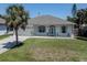 Charming single-story home with a well-maintained lawn, and a light-colored exterior at 5931 Plover Rd, Venice, FL 34293