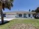 Charming single-story home with white exterior, light blue shutters, and a well-manicured lawn at 5931 Plover Rd, Venice, FL 34293