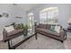 Bright living room featuring two sofas, arched windows and glass coffee table at 5931 Plover Rd, Venice, FL 34293
