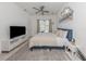 Comfortable main bedroom with a ceiling fan, stylish chandelier and a view of the pool outside at 5931 Plover Rd, Venice, FL 34293