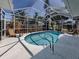 Screened-in pool area with lounge chairs, a kidney-shaped pool, and a view of the backyard at 5931 Plover Rd, Venice, FL 34293