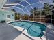 Screened-in pool and patio area featuring a blue pool with a lounge chair, a private outdoor space at 5931 Plover Rd, Venice, FL 34293
