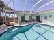 Beautiful backyard pool area with screened-in patio, perfect for outdoor entertaining and relaxation at 5931 Plover Rd, Venice, FL 34293