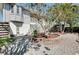 A backyard with brick pavers, beautiful landscaping, a gazebo, and a stairway leading up to the home at 610 Alligator Dr, Venice, FL 34293