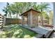 Charming backyard featuring a gazebo, putting green, and privacy fence at 610 Alligator Dr, Venice, FL 34293