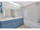Bathroom features a large vanity with white countertop, bathtub and shower with beach themed curtains at 610 Alligator Dr, Venice, FL 34293