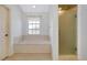 Bathroom featuring a window, tile floors, soaking tub, and glass enclosed shower at 610 Alligator Dr, Venice, FL 34293