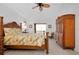 Bright bedroom with wood floors, Tommy Bahama-style furniture, a ceiling fan, and a sliding glass door at 610 Alligator Dr, Venice, FL 34293