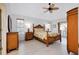 Relaxing bedroom with a ceiling fan, ensuite bathroom, and large windows for natural light and comfort at 610 Alligator Dr, Venice, FL 34293