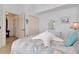 Bright bedroom with beach themed decor, light wood floors, and ample closet space at 610 Alligator Dr, Venice, FL 34293