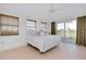 Bright bedroom featuring tile floors, many windows with wood blinds, and sliding door to deck at 610 Alligator Dr, Venice, FL 34293