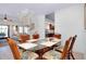 Bright dining area featuring a glass-top table, spiral staircase, and seamless flow to the adjacent kitchen at 610 Alligator Dr, Venice, FL 34293